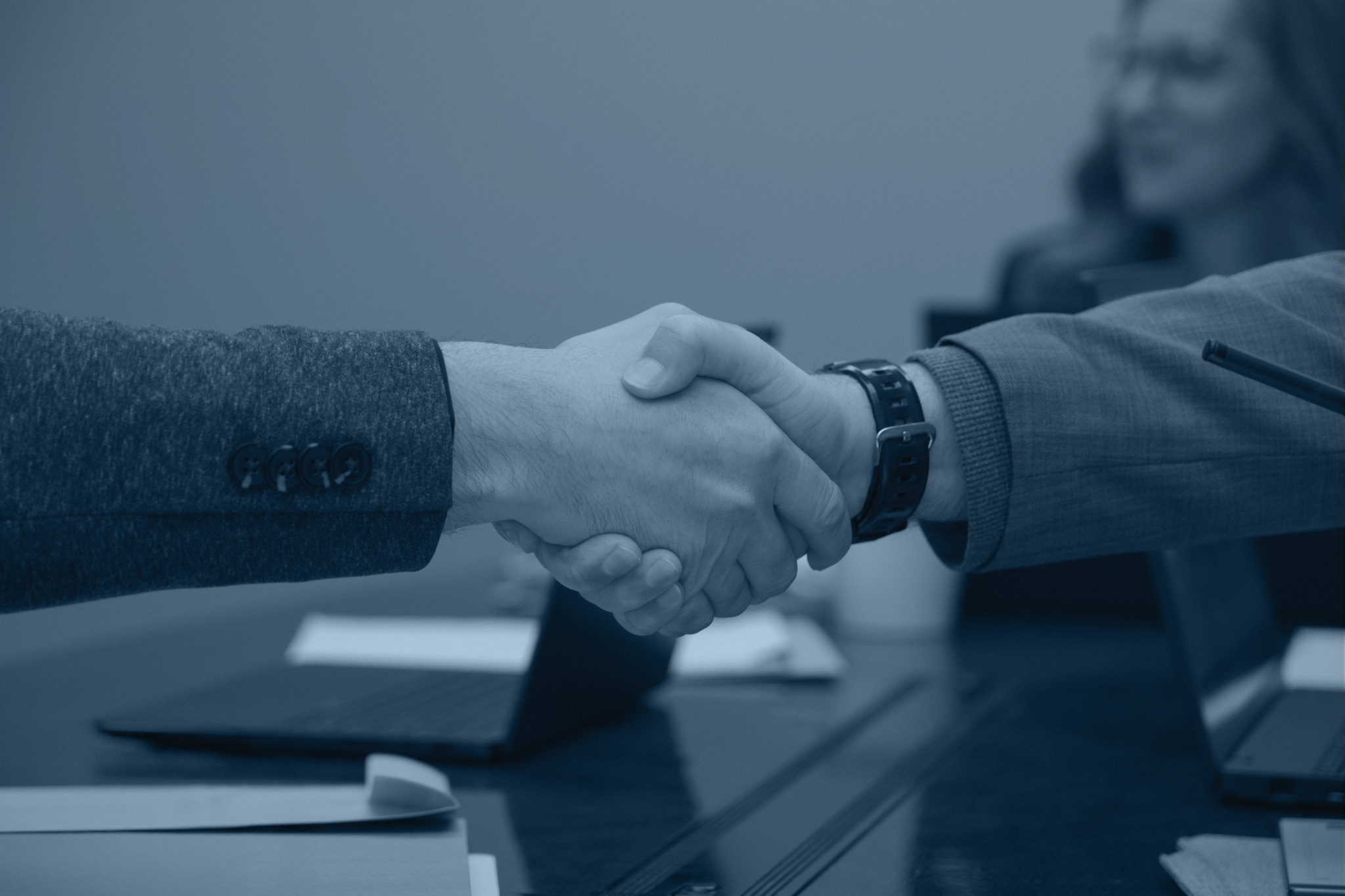 Close up of two business professionals shaking hands.